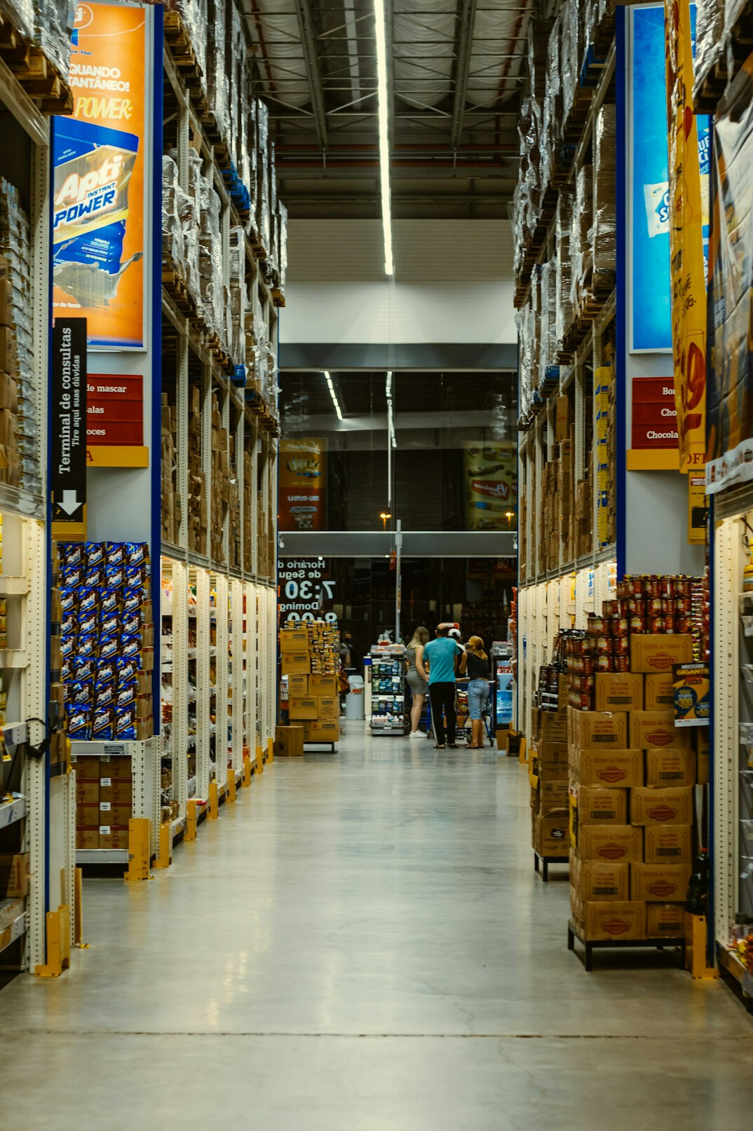 Organized warehouse aisle with shelves and boxes seen from above